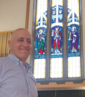 The Rev. Nick Athanasiadis of Leaside Presbyterian and the Memorial Window from the former Glebe church.