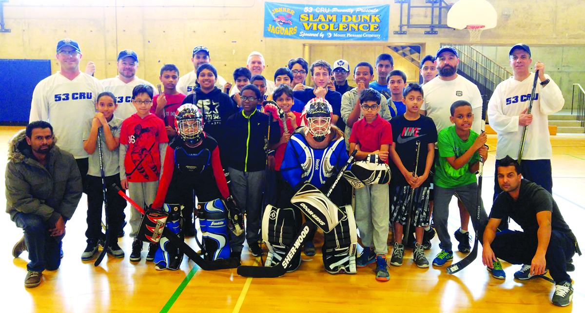 53 Division CRU members with their Thorncliffe Park ball hockey crew. Photo By Karli Vezina.
