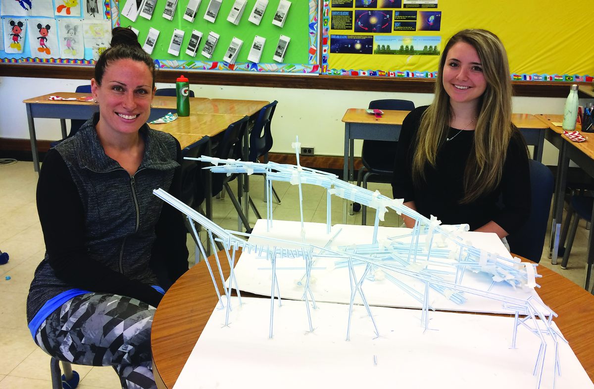 Grade 6 teacher Sarah Buksner and student teacher, Sasha Haber with a roller-coaster made out of plastic straws.