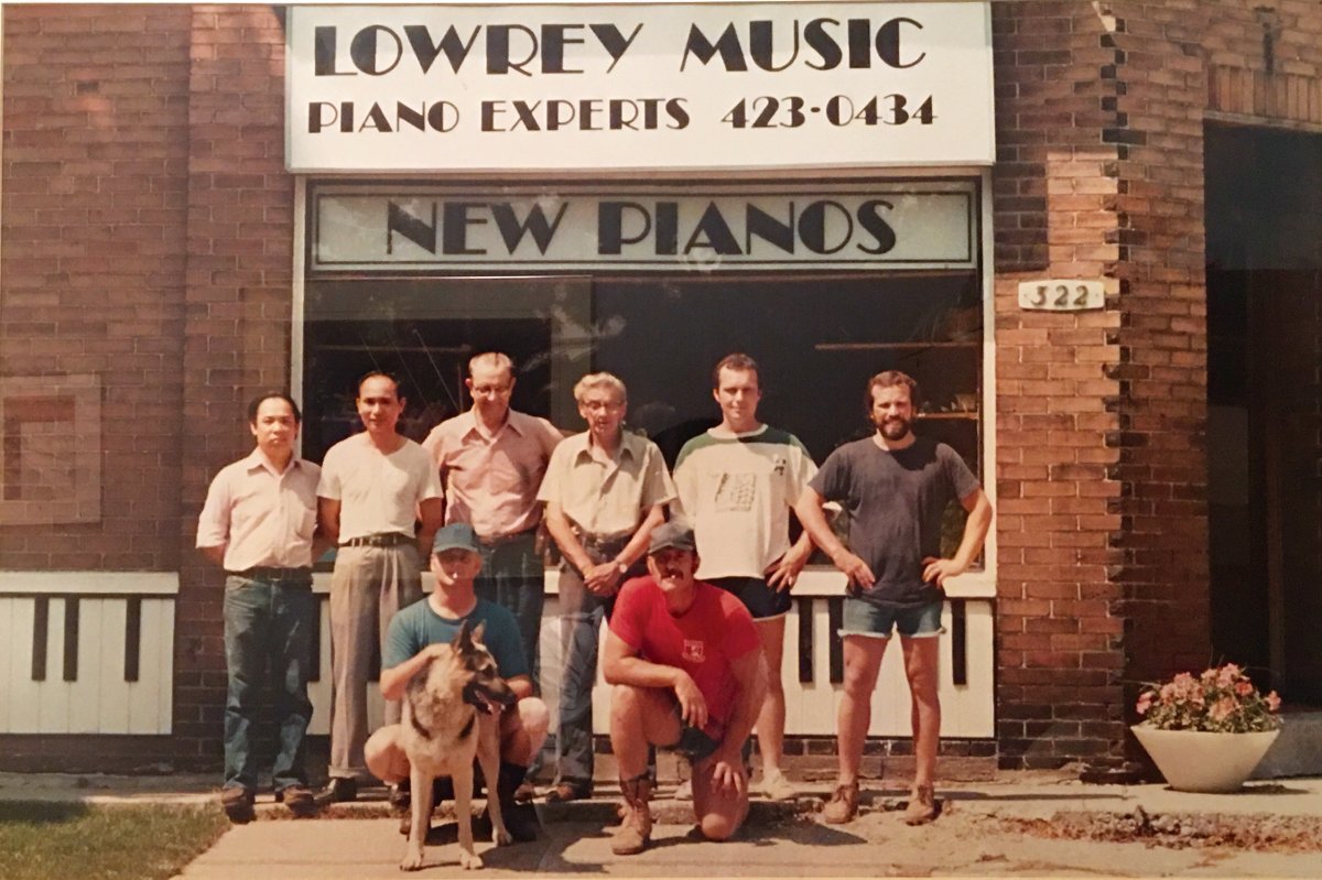 A young Robert Lowrey (far left) in front of the first location of Robert Lowrey Piano Experts at 322 Sutherland Drive.