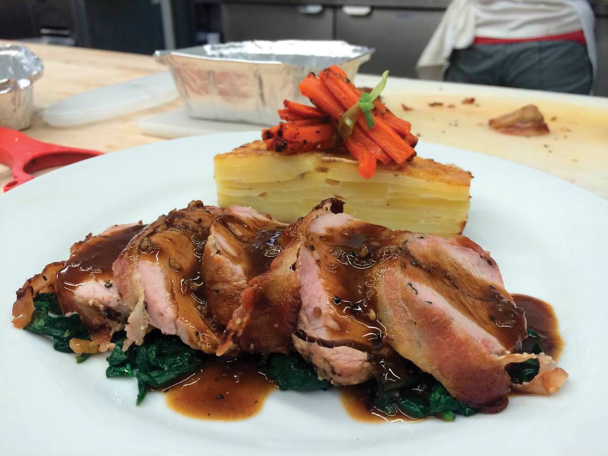 Chris' Gold Medal Pork Tenderloin with peppercorn sauce, dauphinoise potatoes and carrot bundles tied with blanched leeks.