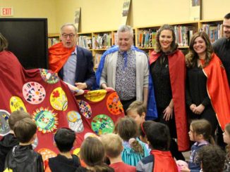 Sandra Hawken, CEO of Holland Bloorview Kids Rehabilitation Hospital, receives a cape made by the students and teachers of Northlea School.