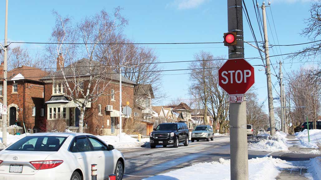 A flashing light above a stop sign in Leaside. Photo by Robin Dickie.