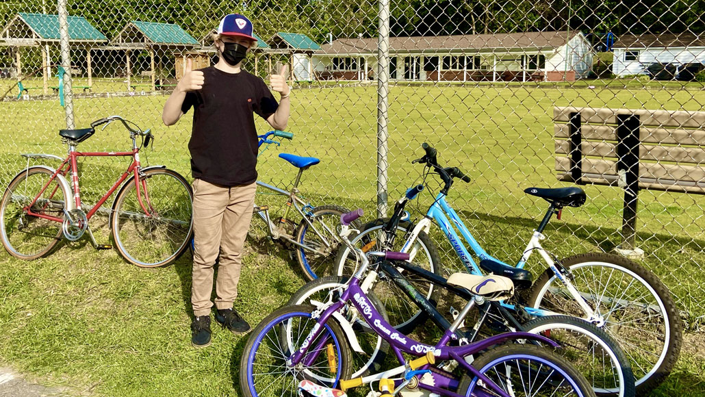 Alec Locklin with bikes he collected for the Gateway Bike Hub. Photo by Holly Reid.