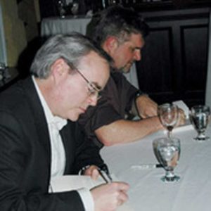 Photo of Terry Fallis and Paul Quarrington signing books.