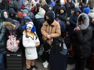 Lviv, Ukraine - March 6, 2022: Refugees near railway station of Lviv waiting for the train to Poland. Photo: Depositphotos, Bumble-Dee.