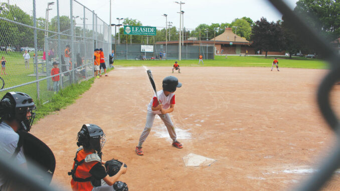 A baseball player gets ready for the pitch.