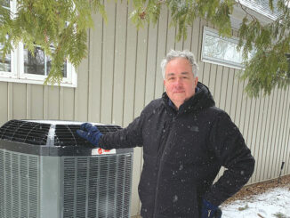 Leasider Tim Short beside a newly installed heat pump at his parents’ home. Photo Tim Short.