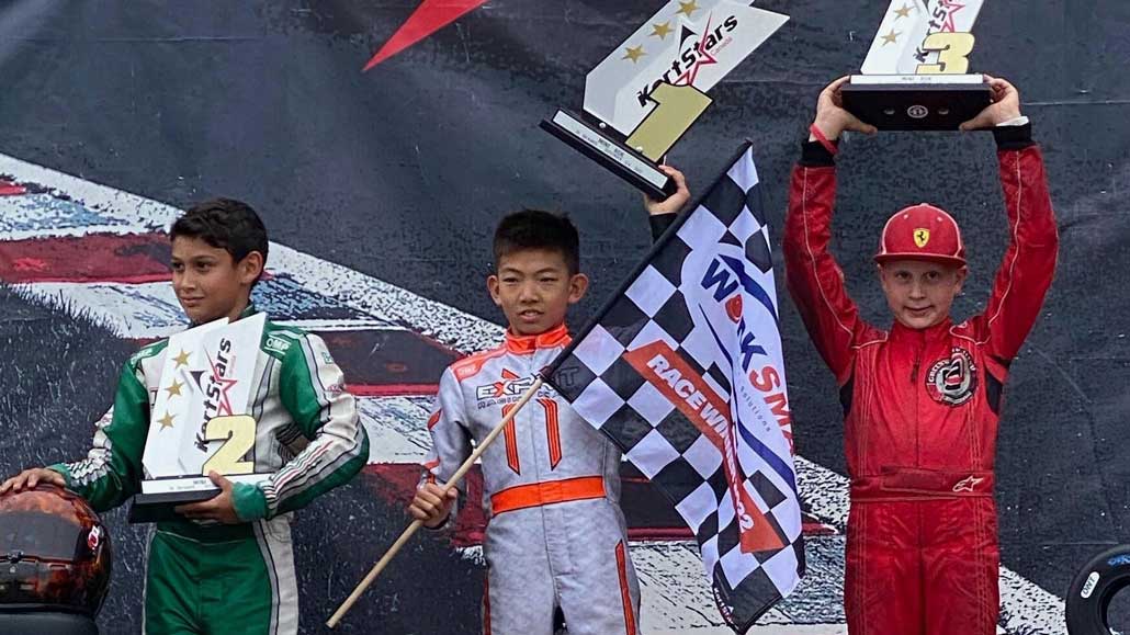 Ethan (far right) celebrating 3rd at the Kart Starts Canada race. Photo Jennifer Morehouse.