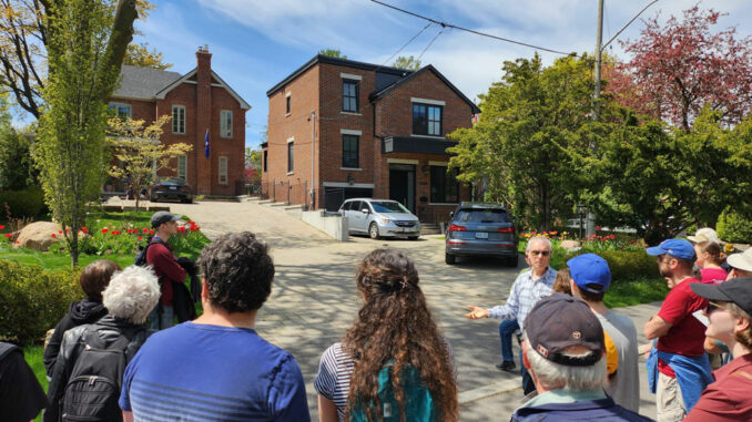 Geoff Kettel leads a group on Leaside’s special Jane’s Walk. Photo Al Toufighi.