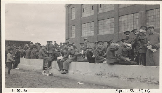 Soldiers having lunch at Canada Wire and Cable factory, Leaside sham battle, April 2, 1915. Photo Toronto City Archives.